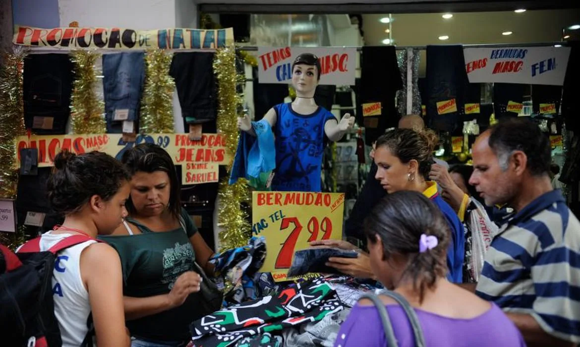 Fachada de lojas no centro de Fortaleza com movimento de consumidores.